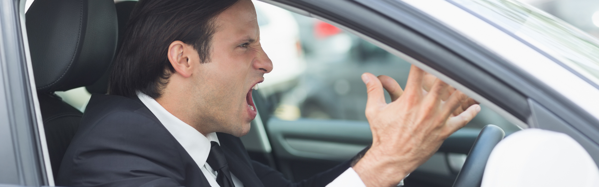 man in business suit with road rage