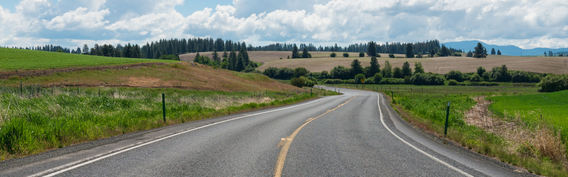 highway with farm fields on either side
