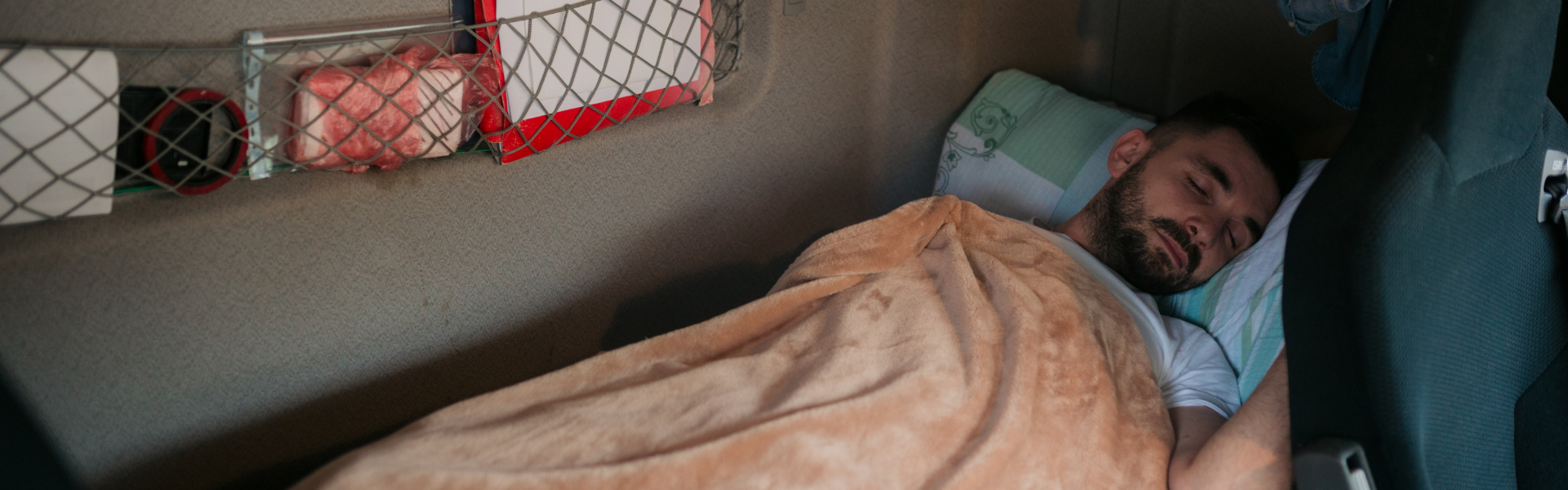 man sleeping in semi truck