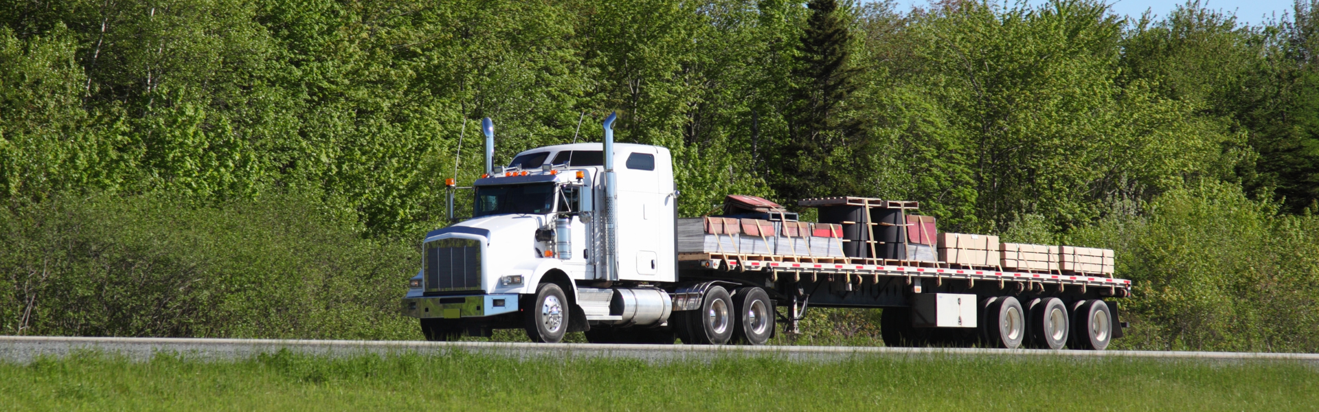 Flat bed semi truck on road