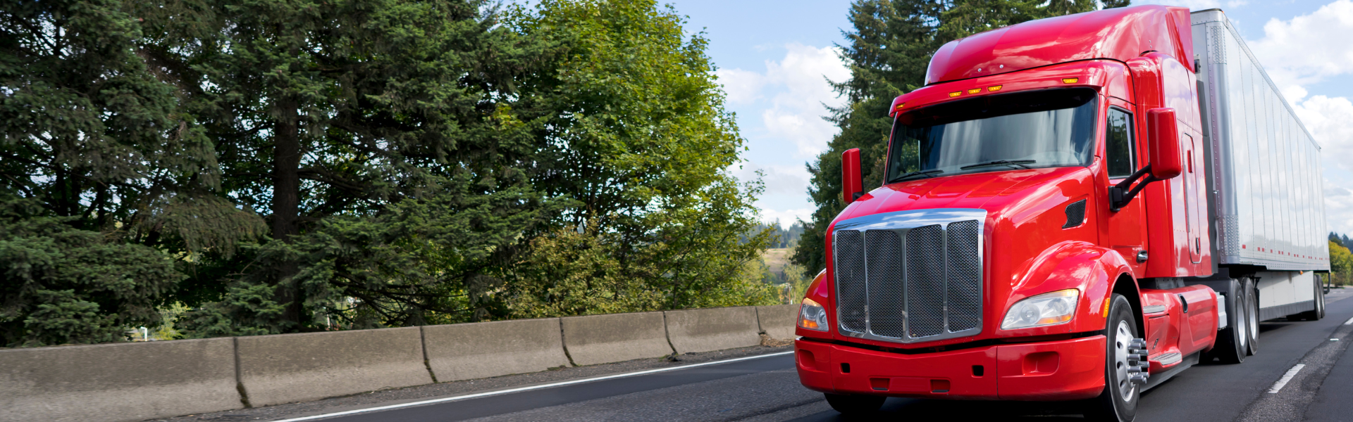 red semi truck with white trailer on road