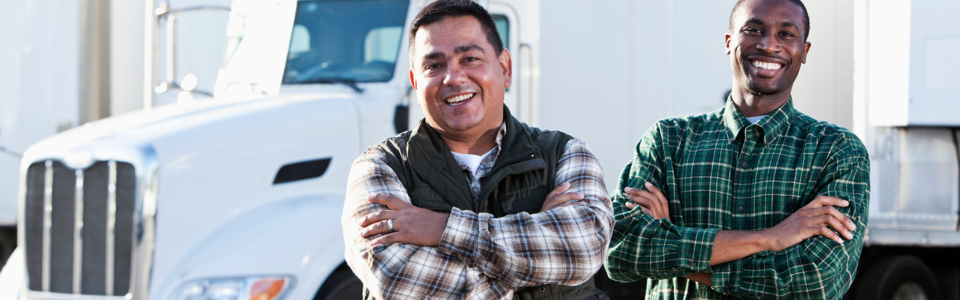 two men standing in front of semi truck