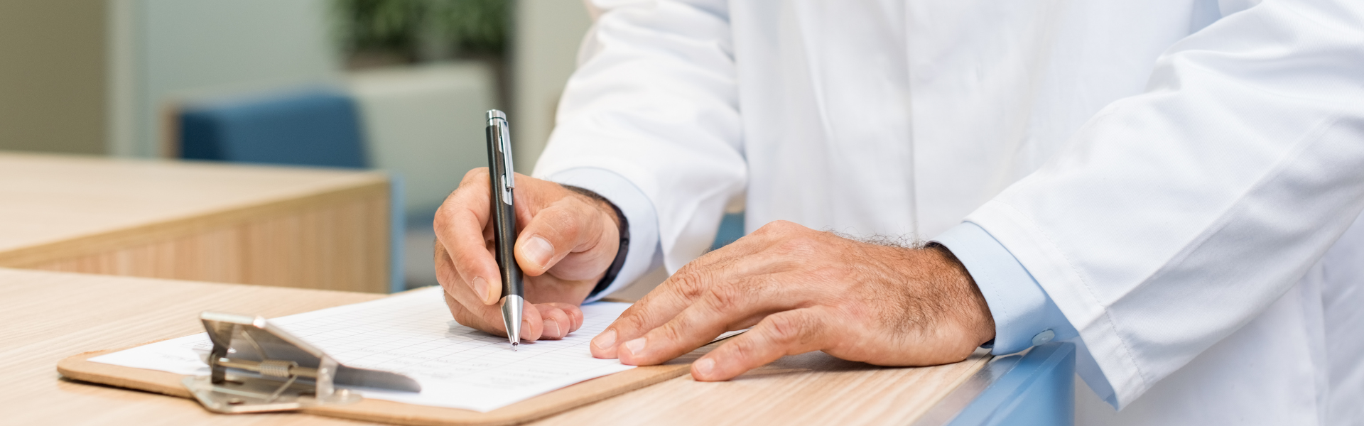 doctor filling out paperwork on clipboard