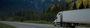 semi truck driving on road with mountain in background