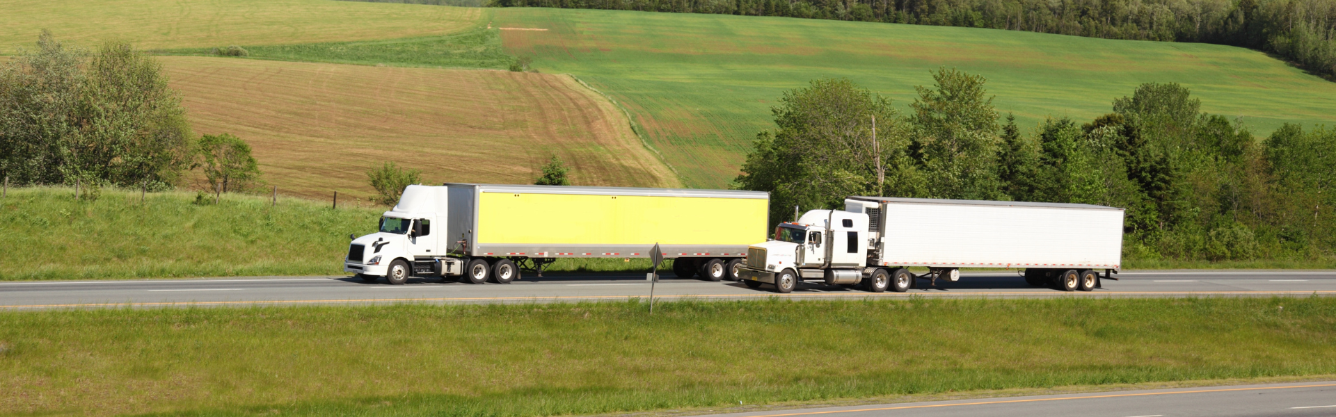semi truck passing another semi truck