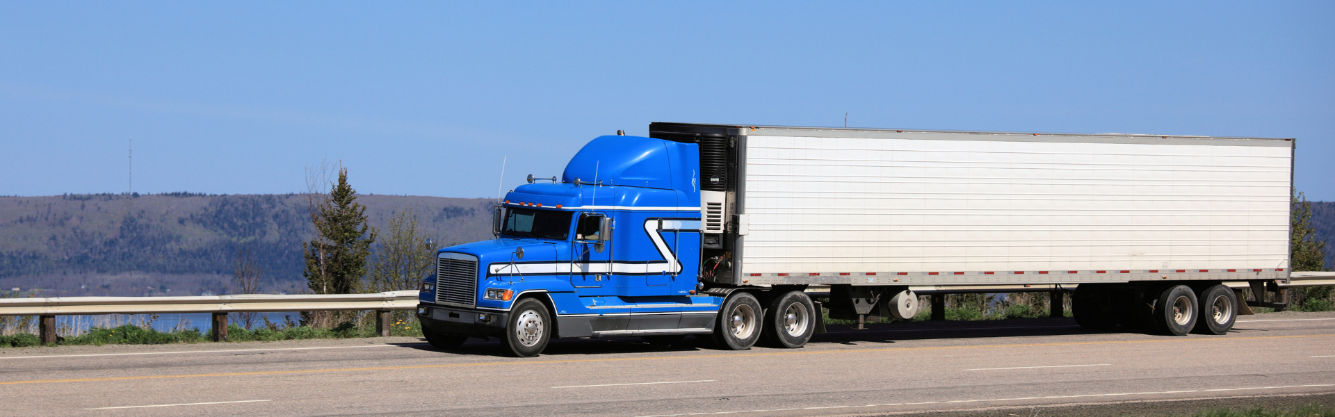 blue semi truck with white trailer