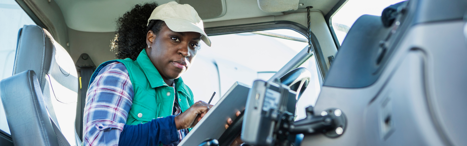 black woman in semi truck cab