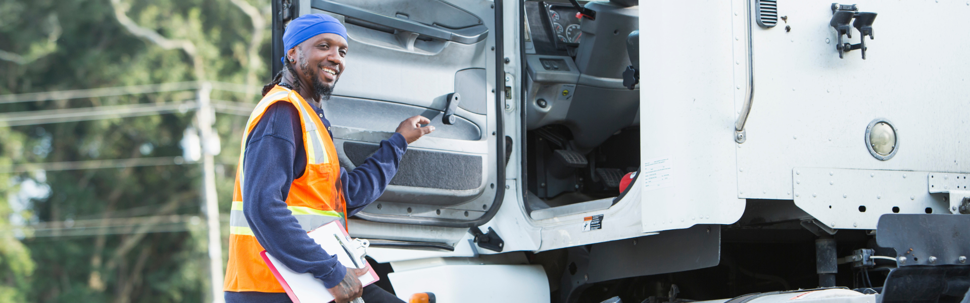 Black man climbing into semi truck cab