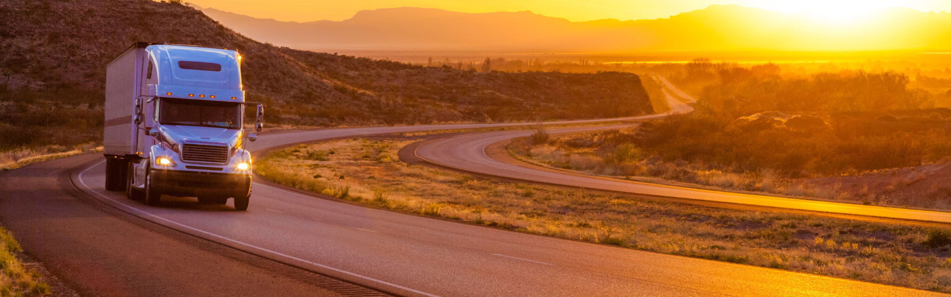 semi truck on interstate at sunset