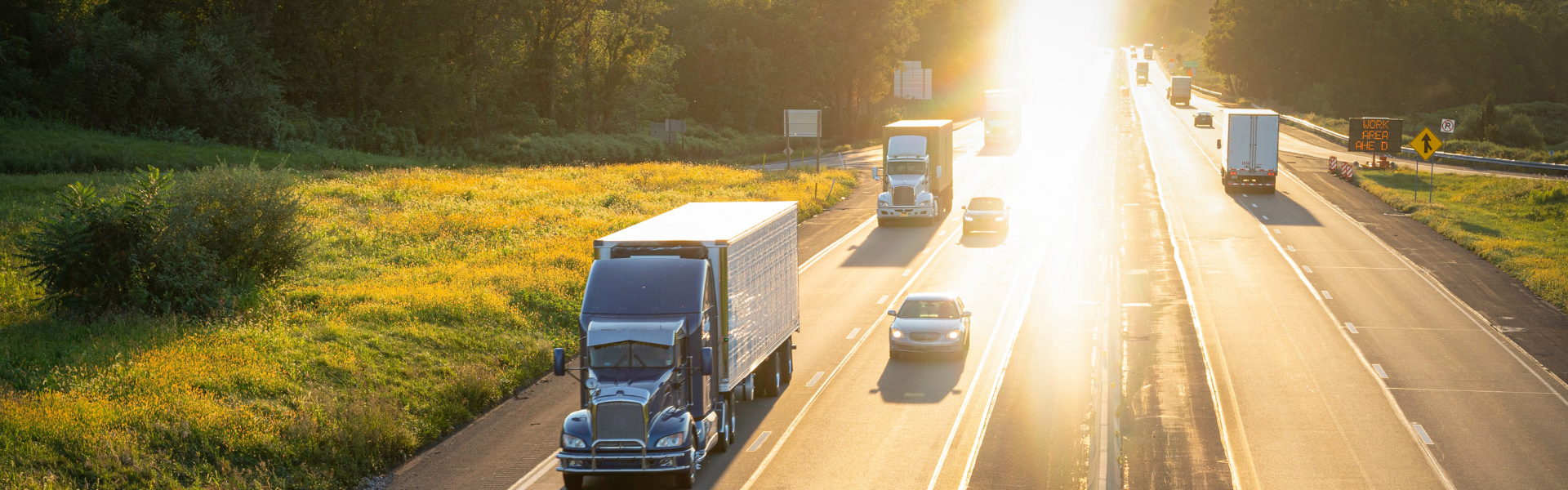 semi trucks and other traffic on sunny highway