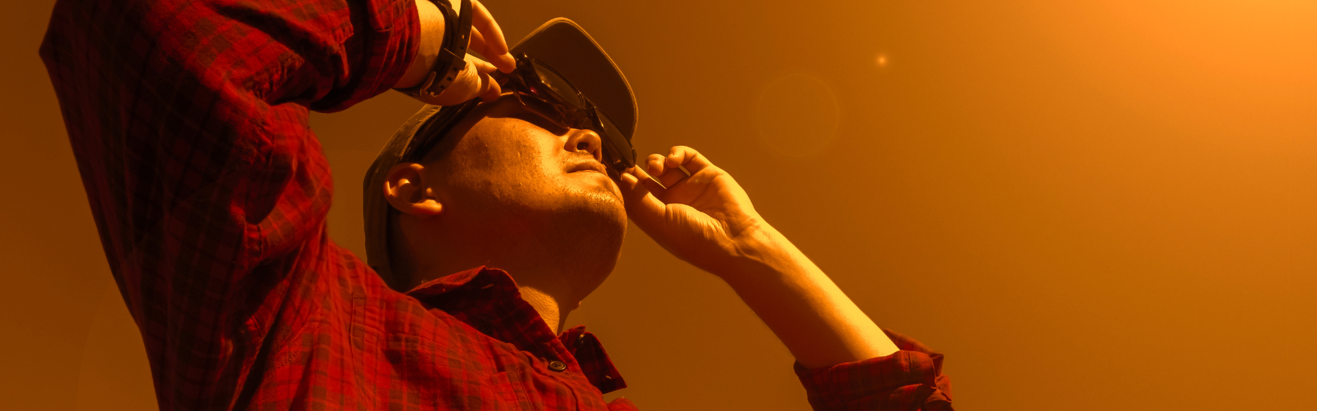 man looking into sun during solar eclipse with glasses