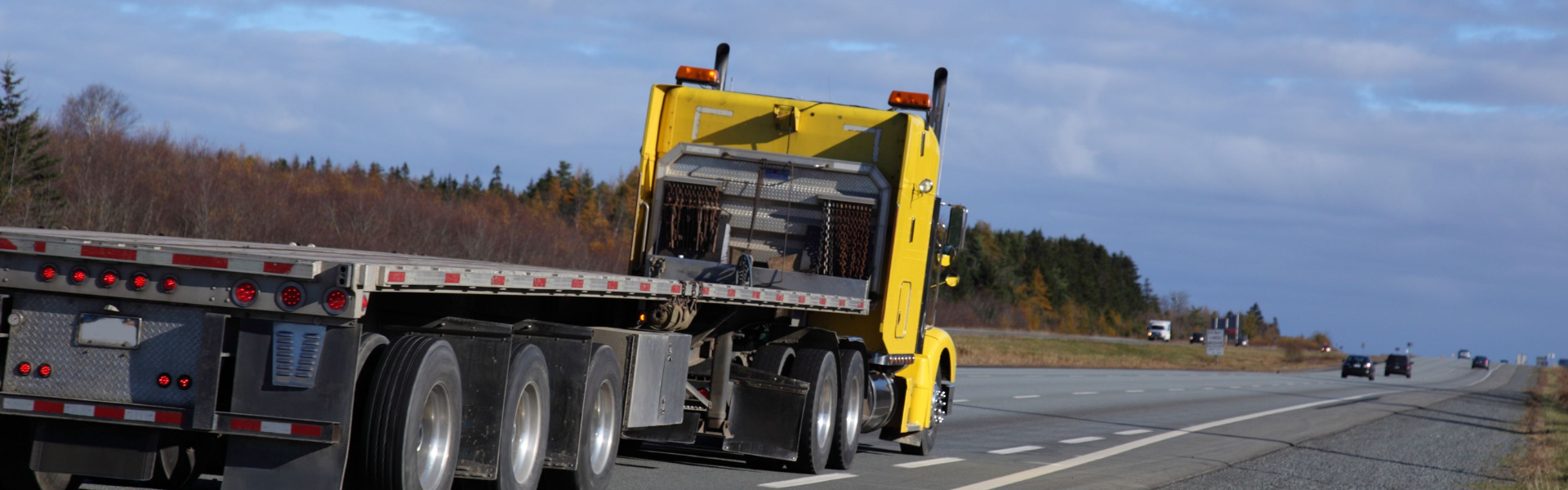 yellow flat bed semi truck