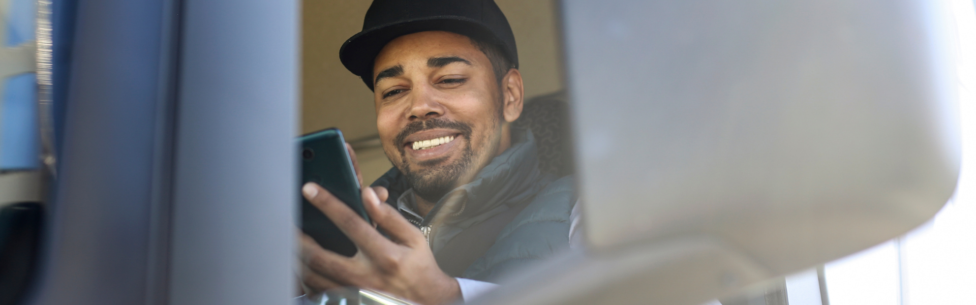 young trucker looking at phone