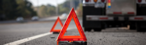safety triangles on roadside with semi truck in background