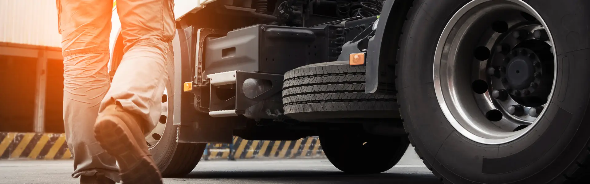 man in work boots walking towards semi truck