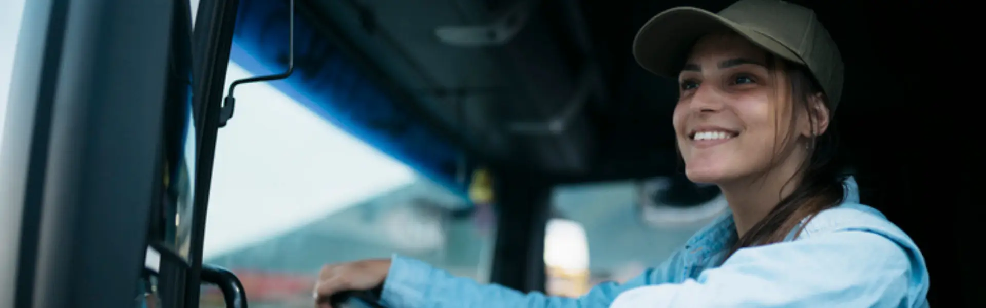 young woman driving semi truck