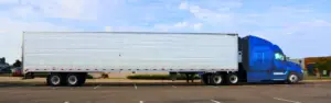 blue semi truck with white trailer