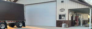 garage with semi truck parked in front - source Overdrive