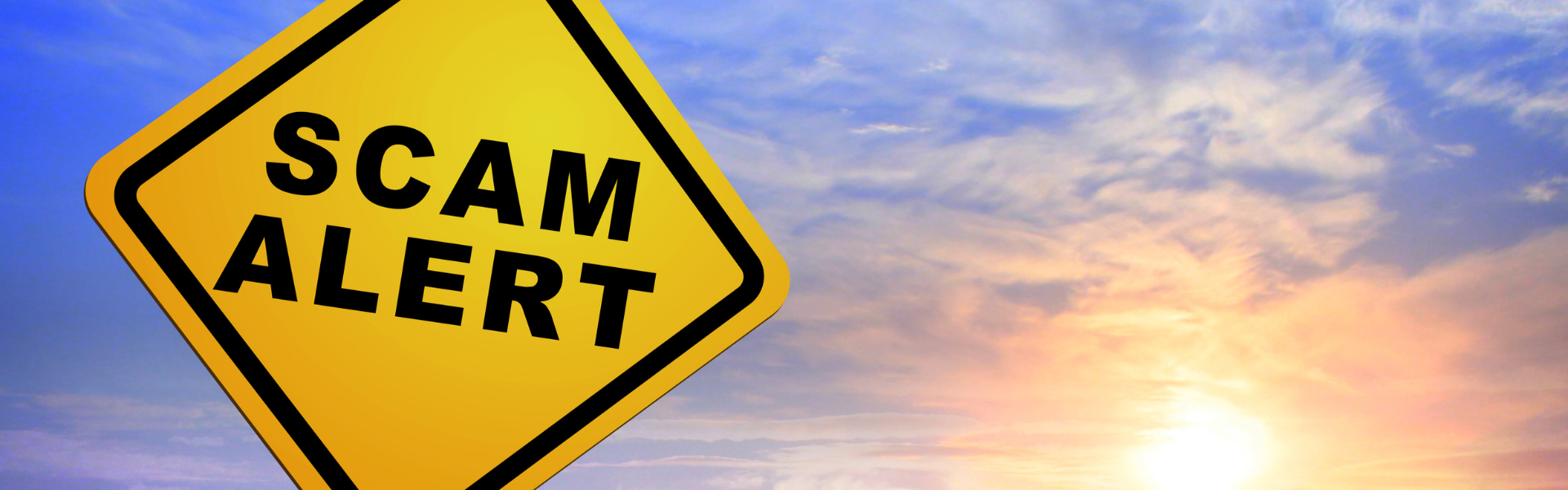 scam alert road sign