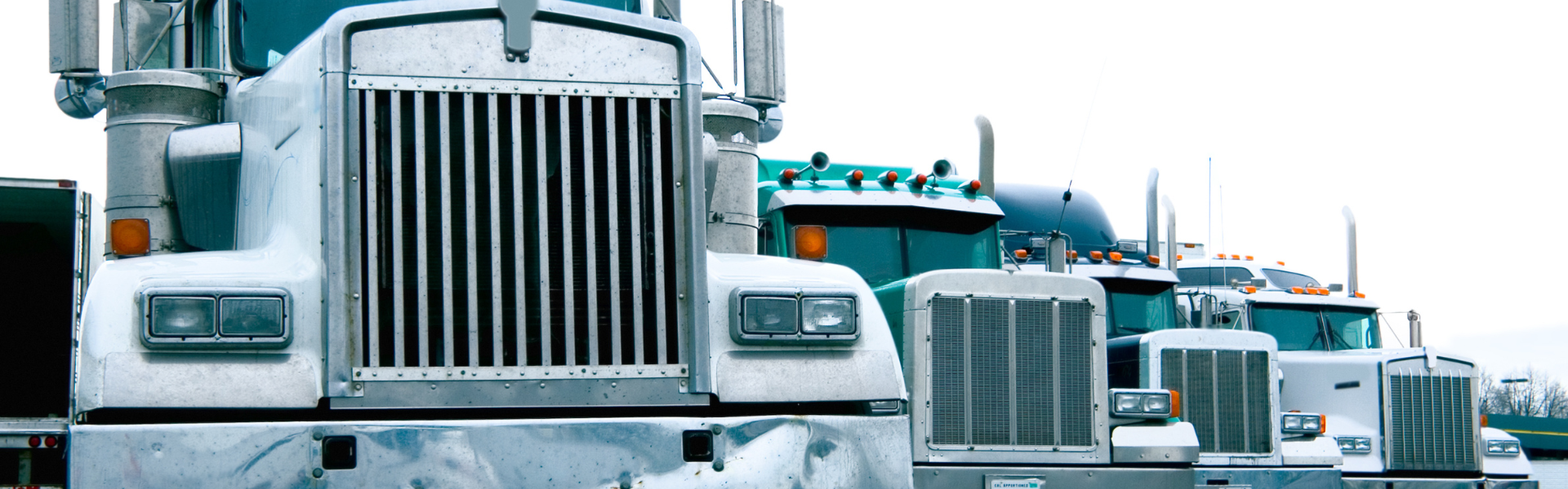 older semi trucks parked in a line