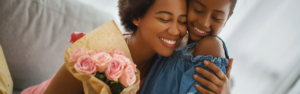 black mother and daughter hugging with bouquet of flowers