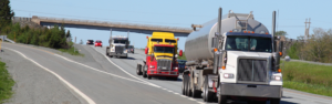 various types of semi trucks traveling on interstate highway