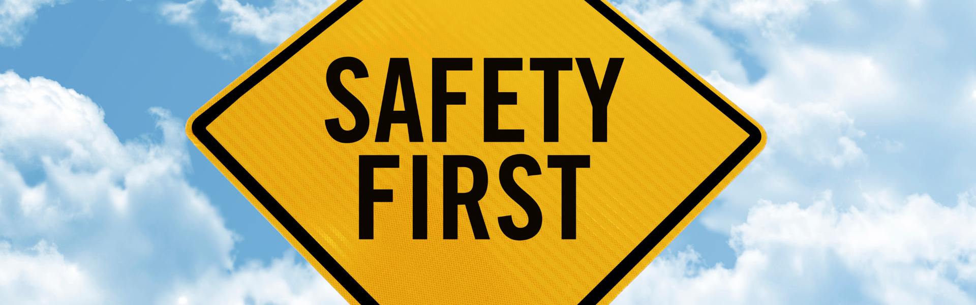 yellow road sign with the words "safety first" printed on it