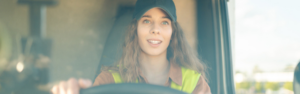 young woman driving semi truck