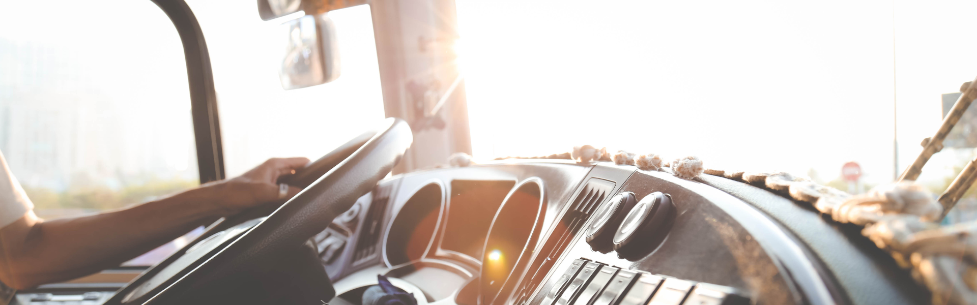 interior of semi truck cab with hand on wheel