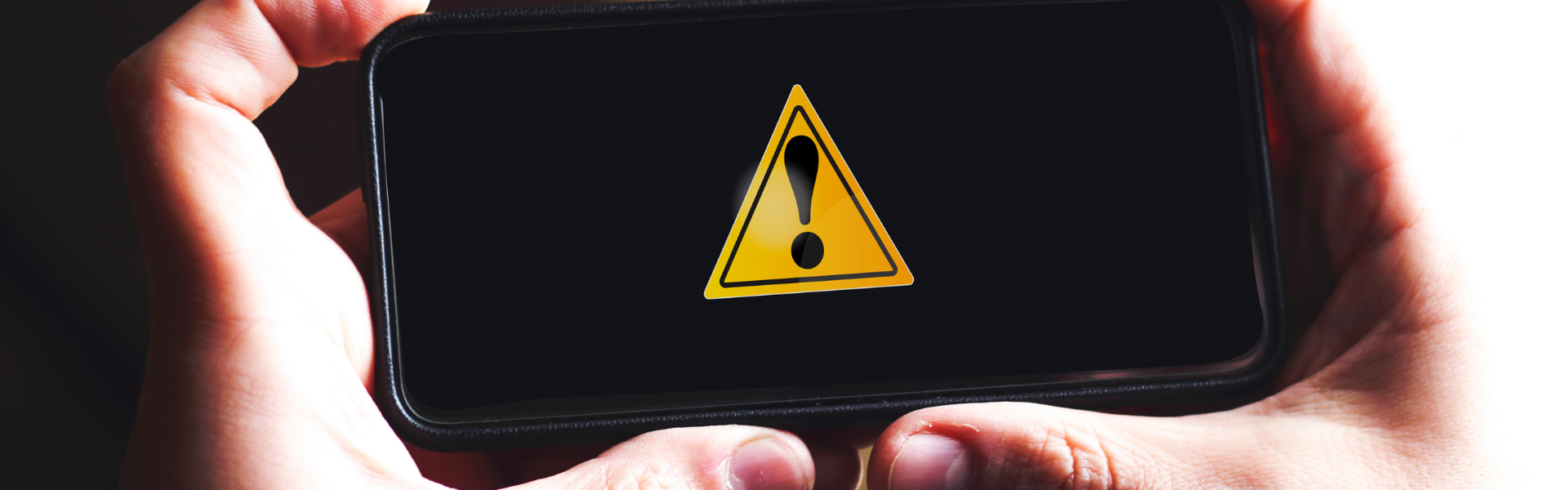 hands holding phone showing an alert notification