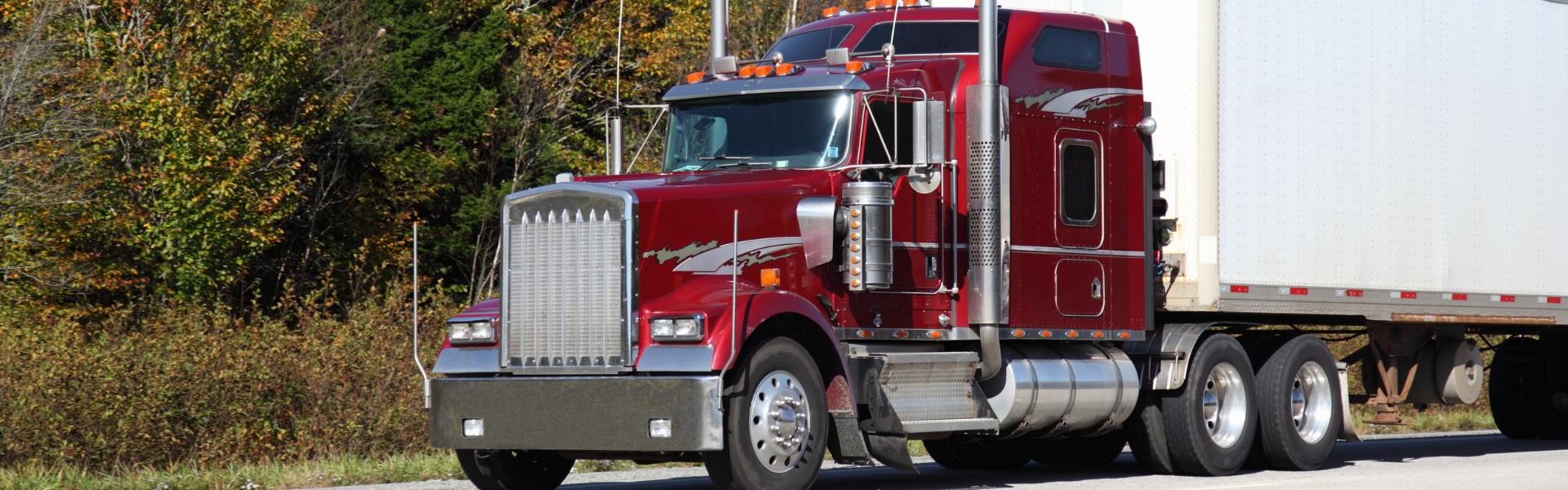 older red semi truck with white trailer