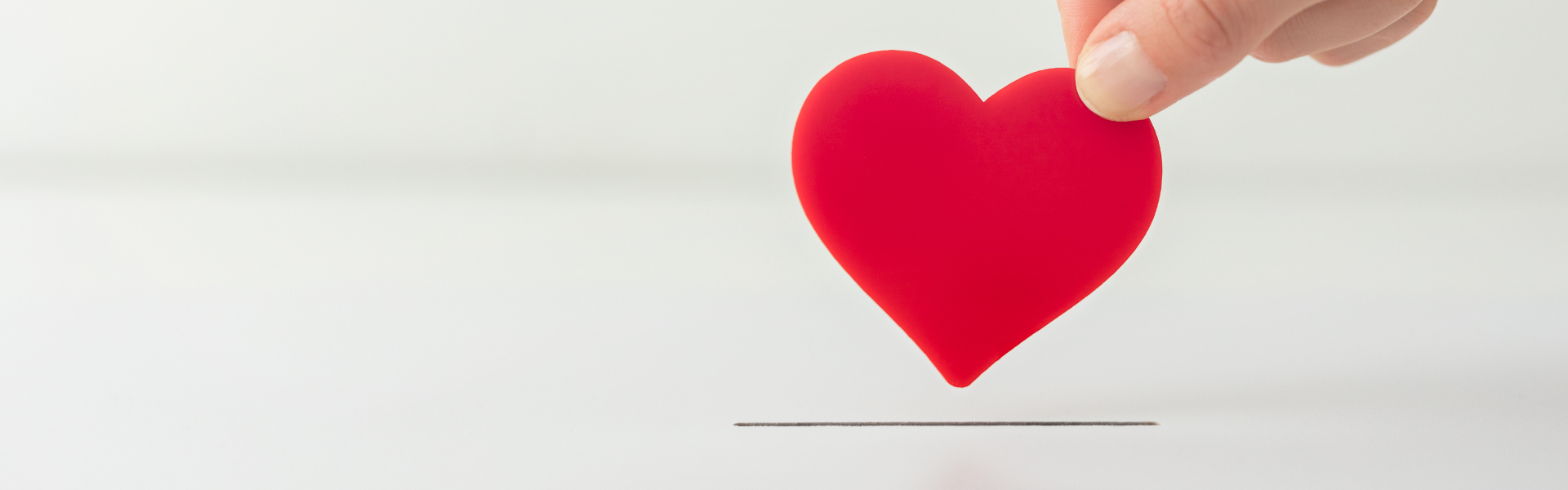 hand placing heart in slot