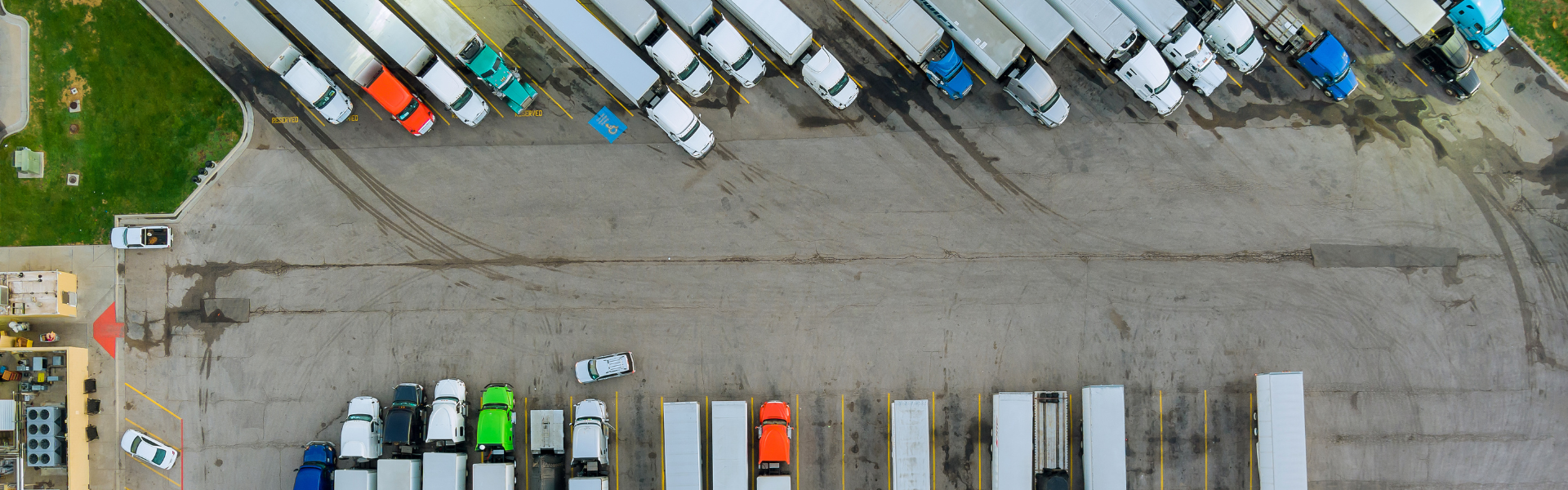 aerial view of semi trucks parked at truck stop