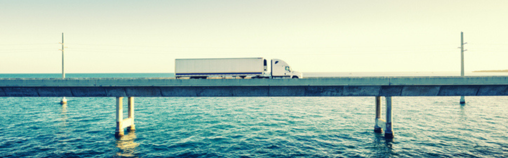 semi truck driving over bridge