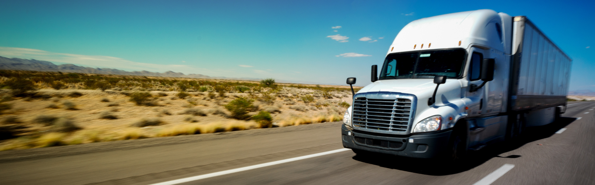 white semi truck on desert road