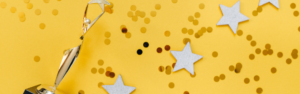 trophy and gold stars with confetti on a yellow background