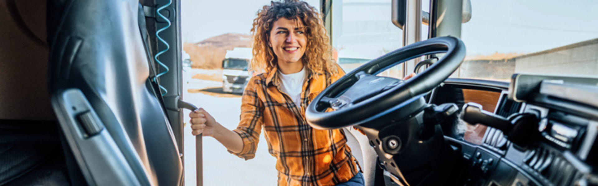 Young woman getting into semi truck cab