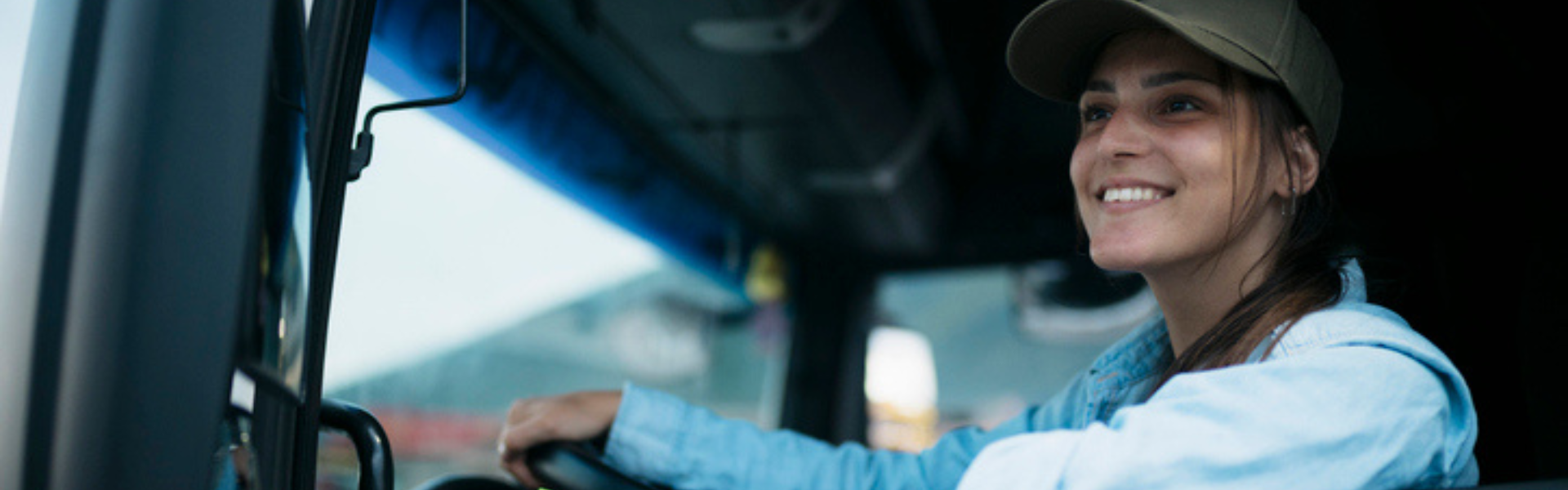 woman in drivers seat of semi truck