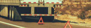 semi truck on side of road with triangles
