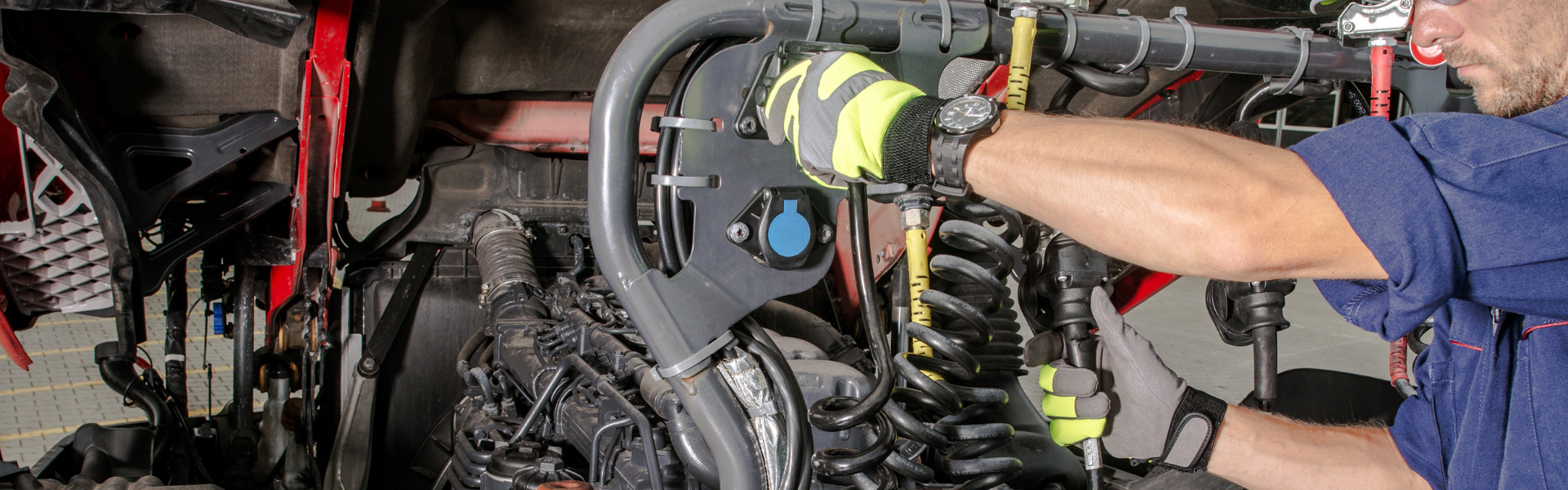 diesel technician working on diesel engine of semi truck