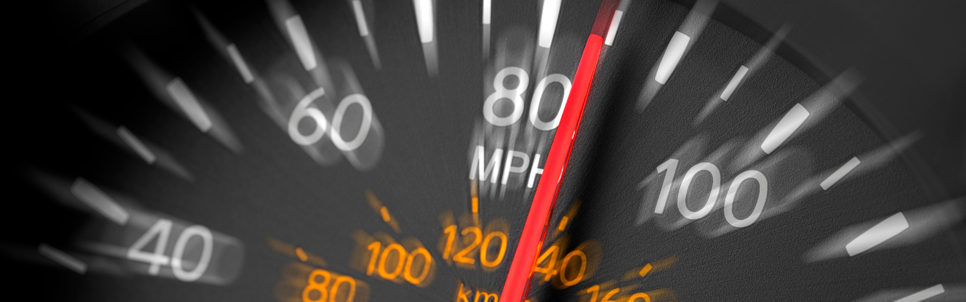 blurry speedometer with the needle indicating speed over 80mph