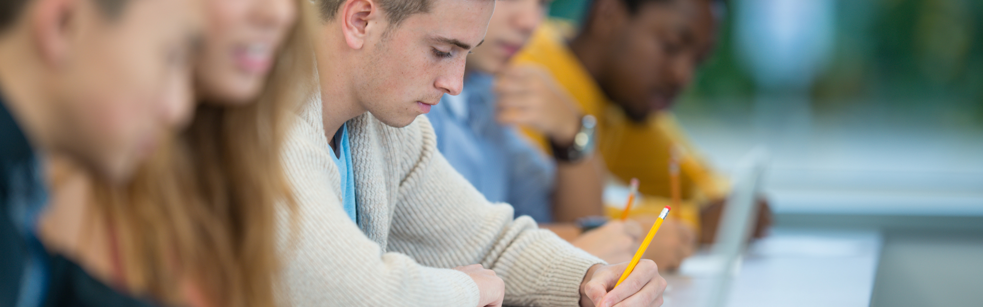 students in classroom at long table
