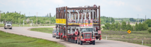 semi truck hauling oversized load on road