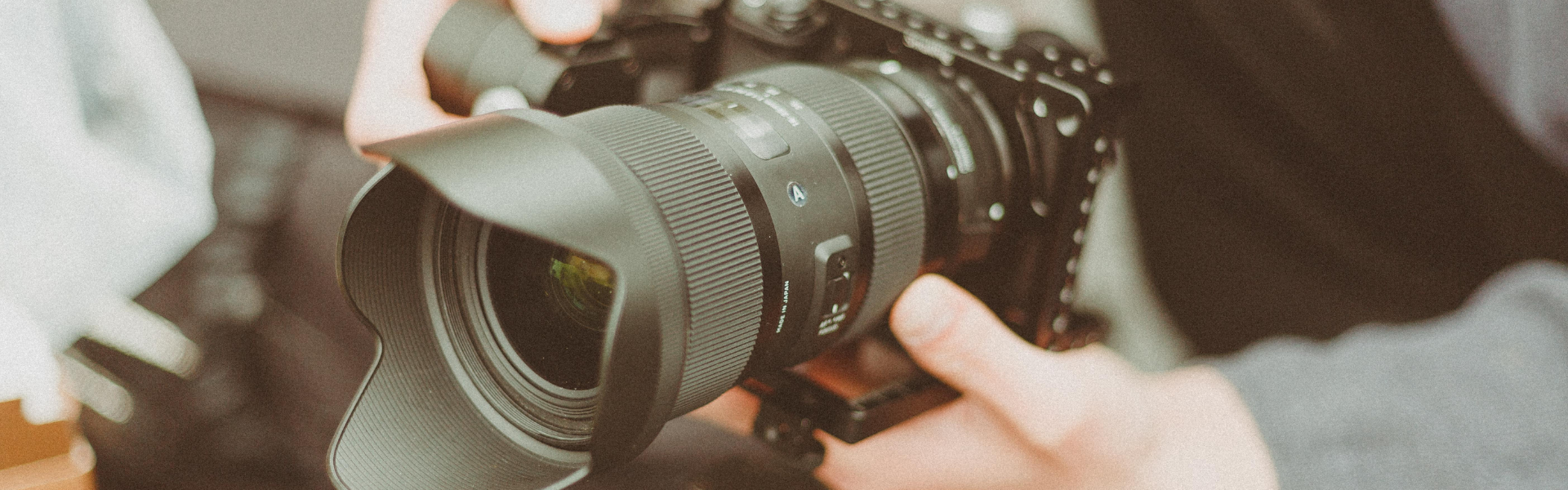 Man holding camera with zoom lens