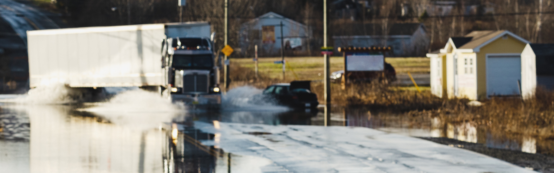 Semi truck driving through flood waters