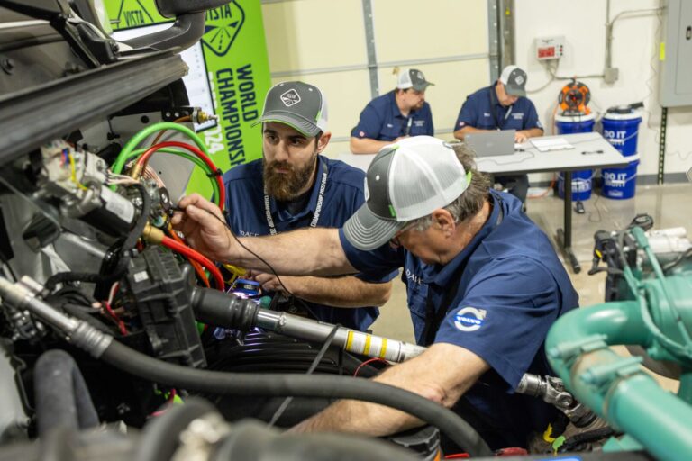 volvo service team working on semi truck diesel engine