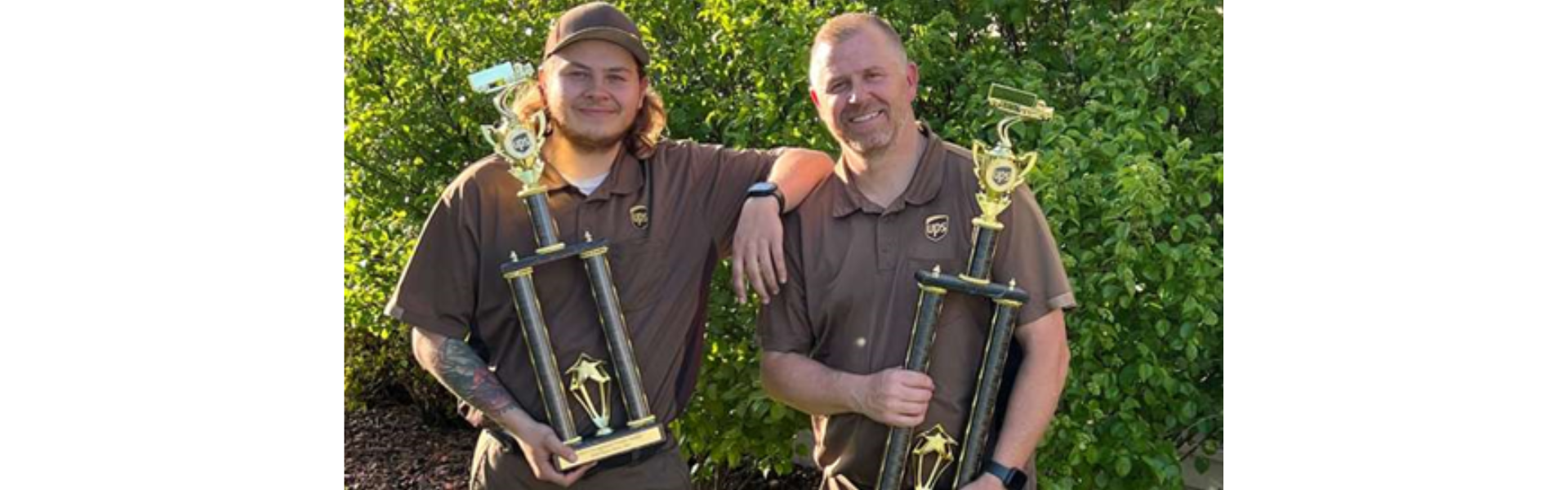 UPS drivers holding National Driving Championship trophies