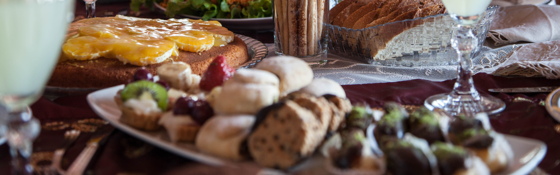 luncheon spread with a variety of food and drinks in stemmed glasses