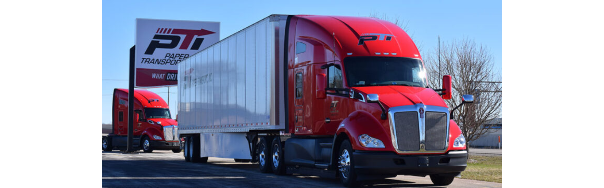 Paper Transport Semi truck in front of Paper Transport sign