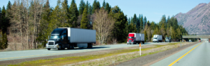 Semi trucks traveling on open highway national truck driver appreciation week